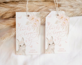 May include: Two white gift tags with pink floral designs and a bunny illustration. The text on the tags reads "Thanks for hopping by" and "Love, Camilla".
