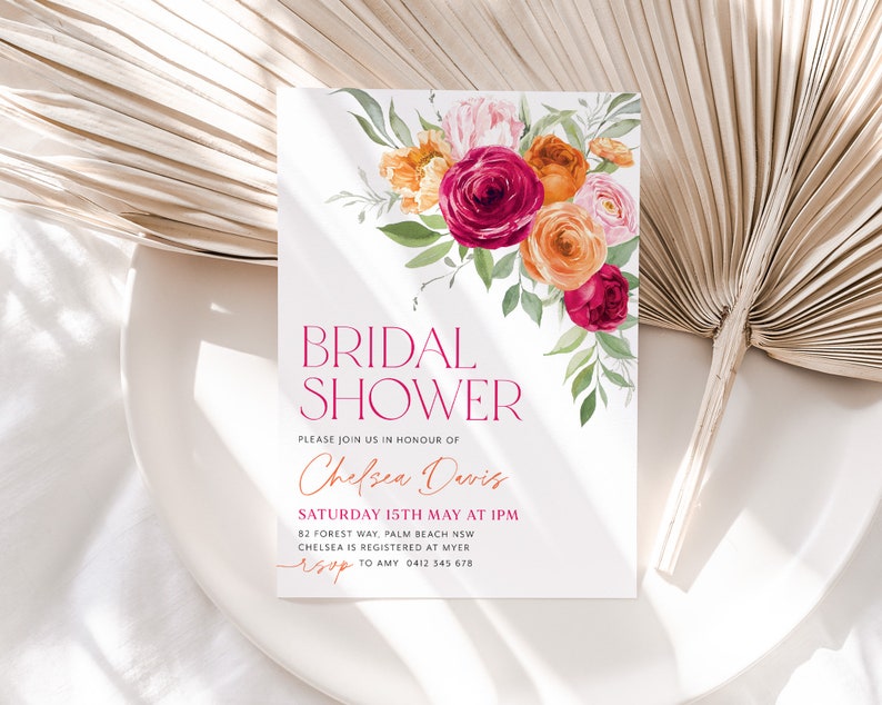 May include: A white bridal shower invitation with a watercolor floral design in shades of pink, orange, and red. The text reads "Bridal Shower" in a bold, modern font, followed by "Please join us in honor of Chelsea Davis" in a cursive script. The invitation includes the date, time, and location of the shower, as well as the registry information and RSVP details.