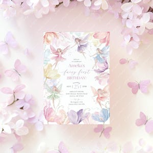 May include: A watercolor invitation with a fairy theme. The invitation features a whimsical design with fairies flying among colorful flowers. The text reads "Join us to celebrate Amelia's fairy first birthday! Saturday, Aug 25 | 2PM, Amelia's House, 4101 Skinner Hollow Road, Azalea, OR 97410, By August 15th, Jenna 0412 343 478".