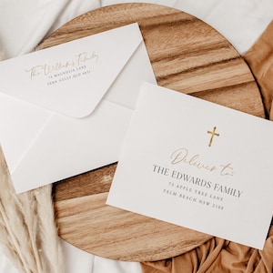 May include: Two white envelopes and a card with gold text. The envelope reads "The Williams Family" and address. The card reads "Deliver to: The Edwards Family" with address and a gold cross.