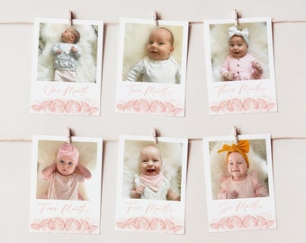 May include: Six monthly photos of a baby girl, each photo is displayed in a white frame with a pink butterfly design and the age of the baby in months written below the photo. The photos are hung on a white wall with string and clothespins.