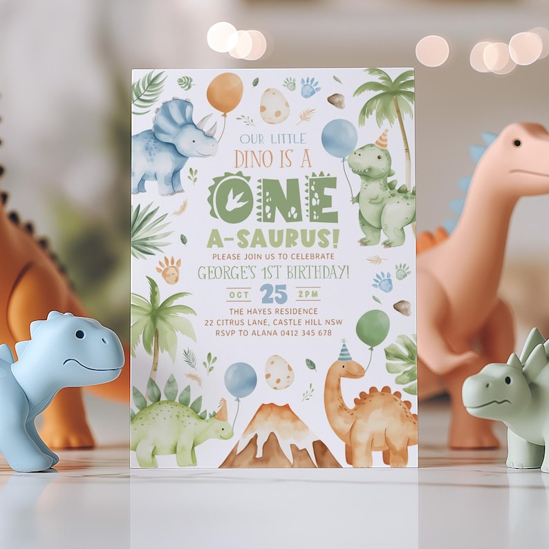 May include: A green, blue, and brown dinosaur-themed first birthday party invitation with the text "Our Little Dino is a One-A-saurus!" and "Please join us to celebrate George's 1st Birthday!"  The invitation also includes the date "Oct 25 2PM", the location "The Hayes Residence, 22 Citrus Lane, Castle Hill NSW", and the RSVP information "RSVP to Alana 0412 345 678".