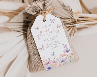 May include: A white favour tag with a watercolour floral design and butterflies. The tag says "Thanks for fluttering by to celebrate with me! Isabella's 1st Birthday 12.05.2026".