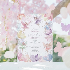 May include: A watercolor invitation with a fairy theme. The invitation features a floral background with fairies flying around. The text reads "Join us to celebrate Amelia's fairy first birthday! Saturday, August 25th, 2 PM. Amelia's House, 4505 Skinner Hollow Road, Azales, OR 97410. By August 15th, Jenna 0412 345 678."