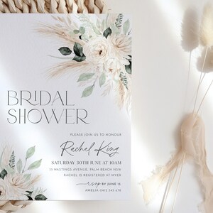 Op de afbeelding: Een witte kaart met een aquarel bloemenontwerp en de tekst "BRIDAL SHOWER" in zwart. De kaart bevat ook de tekst "PLEASE JOIN US TO HONOUR Rachel King SATURDAY 30TH JUNE AT 10AM 35 HASTINGS AVENUE, PALM BEACH NSW RACHEL IS REGISTERED AT MYER RSVP BY JUNE 15 AMELIA 0412 345 678"