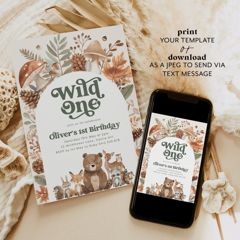 May include: A printable invitation for a first birthday party with a woodland theme. The invitation features a brown bear, a fox, a rabbit, an owl, and a raccoon. The text on the invitation reads "Wild One" and "Oliver's 1st Birthday".