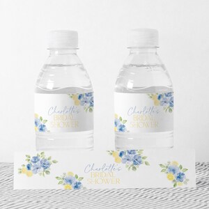 May include: Water bottle labels with a watercolor floral design in shades of blue and yellow. The labels say "Charlotte's Bridal Shower".