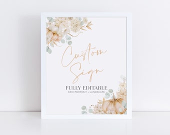 May include: A white framed printable sign with a floral design featuring white and beige flowers, eucalyptus leaves, and a pumpkin. The text on the sign reads "Custom Sign" and "FULLY EDITABLE 8x10 PORTRAIT - LANDSCAPE".