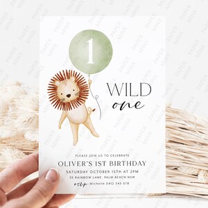 May include: A green and white invitation with a lion holding a green balloon with the number 1 on it. The text reads "WILD one" and "Oliver's 1st Birthday". The invitation includes the date, time, and location of the party.