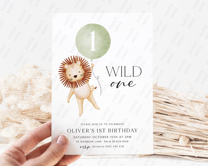 May include: A green and white invitation with a lion holding a green balloon with the number 1 on it. The text reads "WILD one" and "Oliver's 1st Birthday". The invitation includes the date, time, and location of the party.