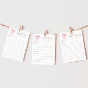 May include: Three printable cards with pink watercolor bows and text that reads "Advice for Parents", "Wishes for Baby", and "Predictions for Baby".
