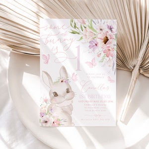 May include: A pastel-colored birthday invitation featuring a bunny illustration and floral accents. The text reads "Some bunny is 1" and includes details for Camilla's 1st birthday celebration, including the date, time, and location.
