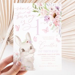 May include: A pastel-colored birthday invitation featuring a bunny illustration with floral accents and butterflies. The text reads "some bunny is 1" and includes details for a first birthday celebration.