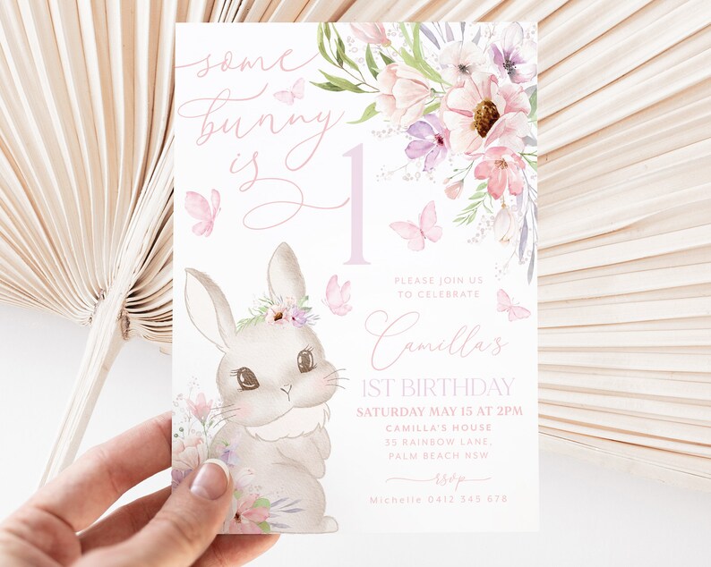 May include: A pastel-colored birthday invitation featuring a bunny illustration with floral accents and butterflies. The text reads "some bunny is 1" and includes details for a first birthday celebration.