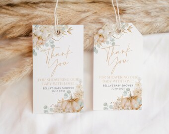 May include: Two white thank you tags with a floral design featuring pumpkins, leaves, and flowers. The text on the tags reads "Thank You" and "For showering our baby with love! Bella's Baby Shower 30.10.2025".