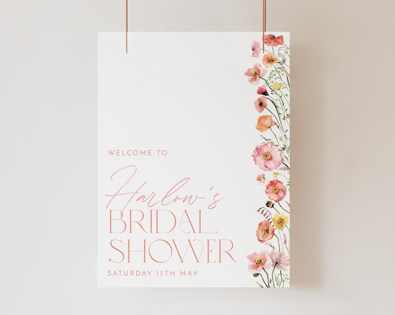 Pu&ograve; includere: Un cartello bianco con accenti floreali rosa e il testo "Benvenuti al Bridal Shower di Harlow Sabato 15 maggio".