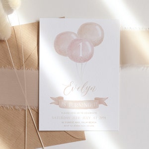 May include: A birthday invitation featuring three pink balloons with the number 1. The invitation includes the name "Evelyn" in elegant script, along with event details: "IS TURNING 1", date, time, and location. The invitation is on a white background.