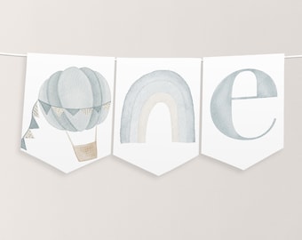 May include: A blue and white watercolor banner with the word "one" spelled out. The "o" is a hot air balloon, the "n" is a rainbow, and the "e" is a simple letter.