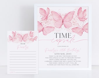 May include: A pink and white time capsule card with butterflies and the text "TIME capsule" and "TO BE OPENED ON Paisley's 18th Birthday! 12TH MAY, 2045 TODAY I'LL BE ONE, TIME PASSES SO FAST THIS TIME CAPSULE IS A WAY TO TREASURE THE PAST WRITE A SWEET MESSAGE, ANY WILL DO A MEMORY, A PREDICTION, WE'LL LEAVE IT UP TO YOU THEN WHEN I GROW UP A GIFT IT WILL BE TO KNOW JUST HOW MUCH YOU ALL LOVED ME!"