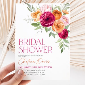 May include: A white bridal shower invitation with a floral design in shades of pink, orange, and red. The text reads "Bridal Shower" in a pink font and "Please join us in honor of Chelsea Davis" in a brown font. The date and time of the shower are listed as "Saturday 15th May at 1pm".