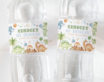 May include: Two clear plastic water bottles with labels featuring a dinosaur theme. The labels are white with green, blue, and orange accents. The text on the labels reads "George's 1st Birthday Thanks for coming!"