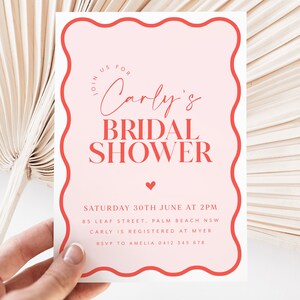 May include: Pink and red bridal shower invitation with a wavy border. The invitation reads "Join us for Carly's Bridal Shower" and includes the date, time, location, and RSVP information.