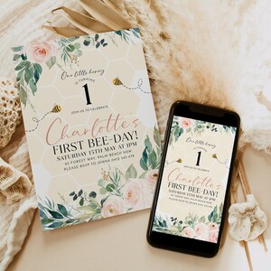 May include: A birthday invitation and a smartphone displaying the same design. The invitation features floral accents, a honeycomb background, and the text "Charlotte's First Bee-Day!" with a bee graphic. The phone shows the same design.