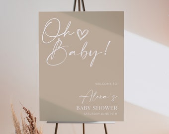 May include: A beige welcome sign with white calligraphy that reads "Oh Baby!" and "Welcome to Alexa's Baby Shower Saturday June 15th".