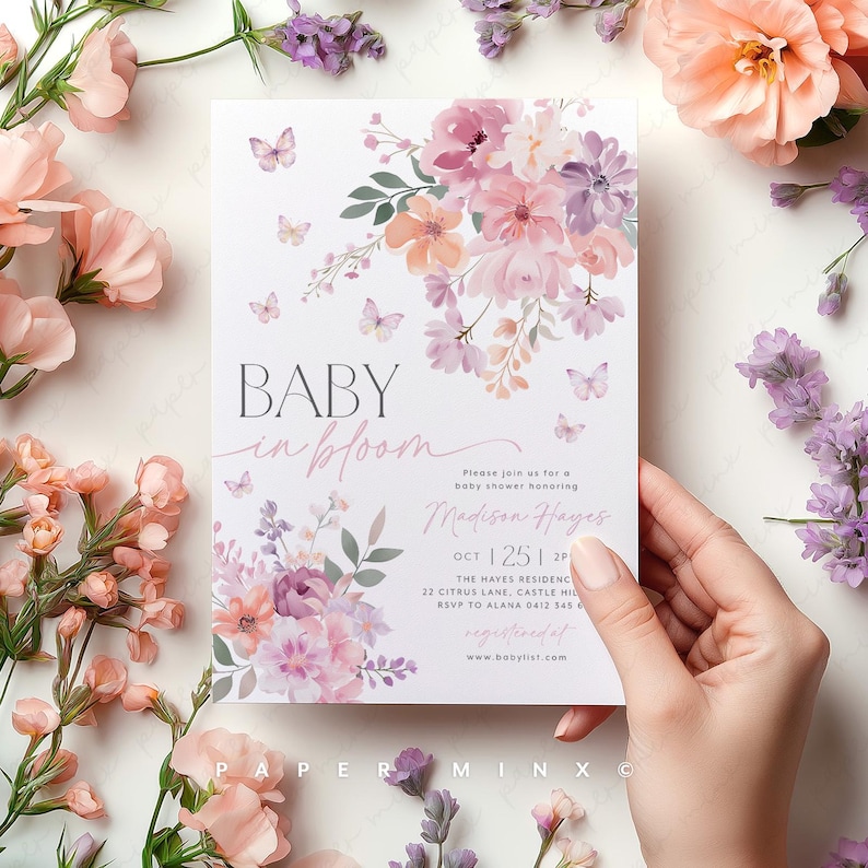 May include: A baby shower invitation featuring a floral design in shades of pink, purple, and peach. The text reads "Baby in Bloom" and includes the name "Madison Hayes" and the date "Oct 25, 2P".