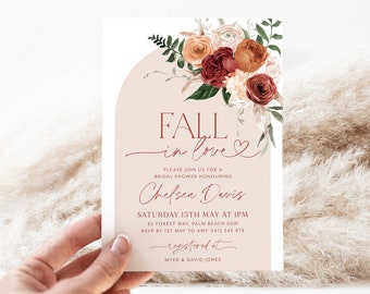 May include: A rectangular bridal shower invitation card featuring a beige arch design, watercolor floral illustrations in shades of burgundy, rust, and cream, and printed text including "FALL in love" and event details for Chelsea Davis.