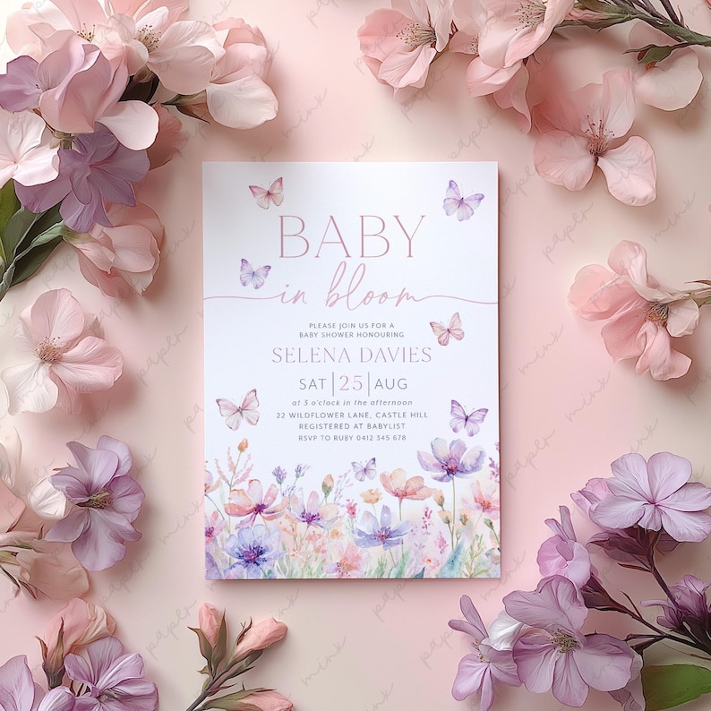 May include: A baby shower invitation with a watercolor floral design featuring butterflies and the text "Baby in Bloom". The invitation is for Selena Davies on Saturday, August 25th.