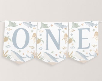 May include: A blue and white banner with the word "ONE" in large, blue letters. The banner is decorated with a watercolor pattern of sea creatures, including whales, stingrays, jellyfish, and starfish.