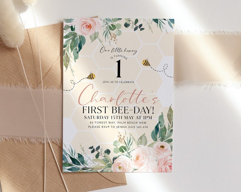 May include: A birthday invitation with a bee theme, featuring a honeycomb pattern and floral accents. The invitation reads "Our little honey is turning 1" and "Charlotte's First Bee-Day!" with event details. The design includes watercolor roses.