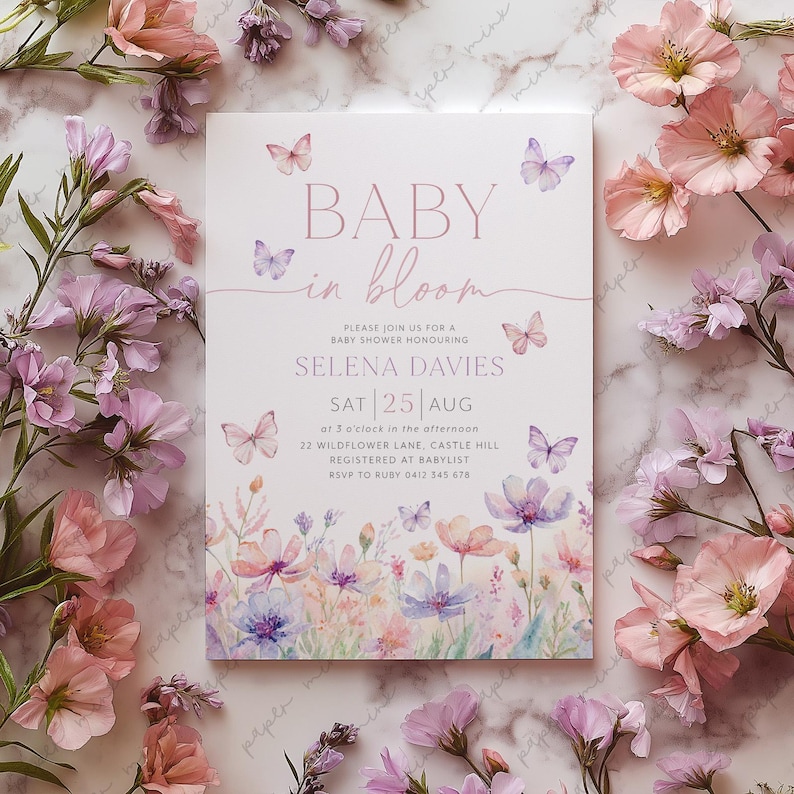 May include: A baby shower invitation with a watercolor floral design and butterflies. The invitation reads "Baby in Bloom" and includes the date, time, and location of the shower. It also includes the name of the guest of honor, Selena Davies, and the RSVP information.