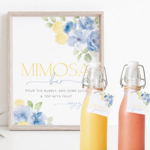 May include: A printable sign for a mimosa bar with a watercolor design of blue flowers and lemons. The sign says "Mimosa Bar" and "Pour the bubbly, add some juice & top with fruit. Enjoy!"