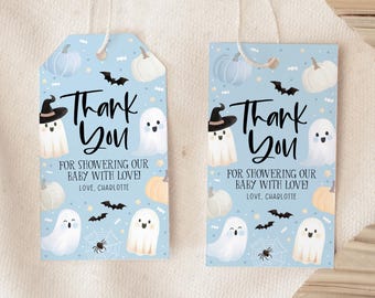May include: Two blue and white thank you tags with a Halloween theme. The tags feature ghosts, pumpkins, bats, and spiders. The text on the tags reads "Thank You" and "For showering our baby with love! Love, Charlotte".