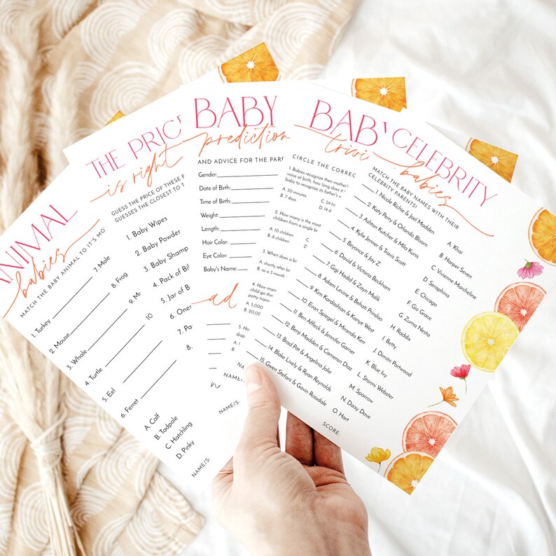 May include: Three printable baby shower game cards with orange citrus fruit illustrations. The first card is titled "Animal Babies" and asks players to match the baby animal to its gestation period. The second card is titled "Baby Prediction" and asks players to guess the baby's gender, date of birth, weight, length, hair color, eye color, and name. The third card is titled "Bab' Celebrity Babies" and asks players to match the baby's name with their celebrity parents.