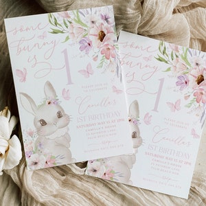 May include: Two invitations with a bunny theme. The invitations feature a watercolor illustration of a bunny, flowers, and butterflies. The text reads "Some bunny is 1" and includes details for a first birthday celebration.