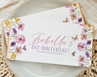 May include: A white chocolate bar with a floral design and the text "Isabella's 1st Birthday! Thanks for coming!" printed on it.