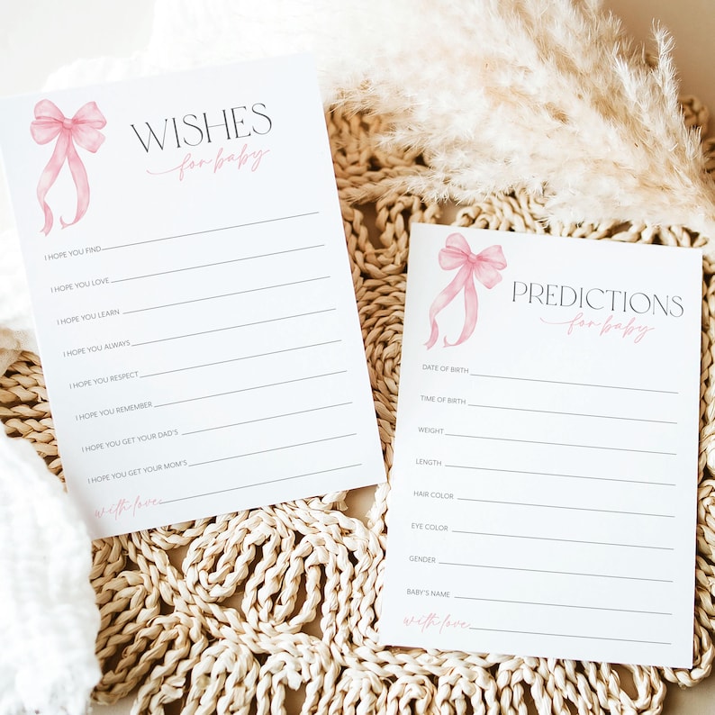 May include: Two printable cards for a baby shower. The top card has a pink bow and the text "WISHES for baby". The bottom card has a pink bow and the text "PREDICTIONS for baby".