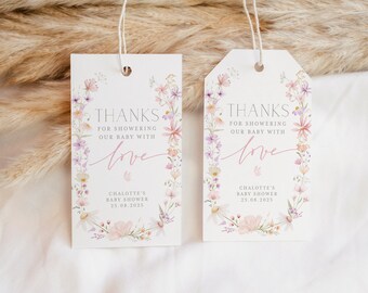 Op de afbeelding: Twee witte bedankkaartjes met een bloemige rand en de tekst "Bedankt voor het verwennen van onze baby met liefde" en "Charlotte's Baby Shower 25.08.2025".