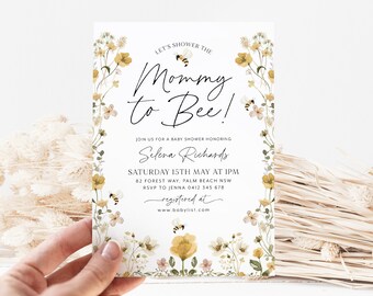 May include: A white baby shower invitation with a floral border and the text "Let's shower the Mommy to Bee!"  Join us for a baby shower honoring Selena Richards. Saturday 15th May at 1pm. 82 Forest Way, Palm Beach NSW. RSVP to Jenna 0412 345 678. Registered at www.babylist.com