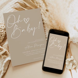 May include: A beige baby shower invitation with white calligraphy that reads "Oh Baby!"  The invitation includes the name "Alexa Morgan" and details for the event. A matching digital invitation is displayed on a smartphone.