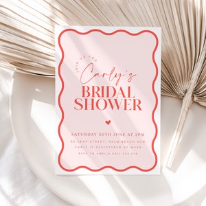 May include: Pink and red bridal shower invitation with a wavy border. The invitation reads "Join us for Carly's Bridal Shower" and includes the date, time, location, and RSVP information.
