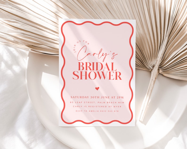 May include: Pink and red bridal shower invitation with a wavy border. The invitation reads "Join us for Carly's Bridal Shower" and includes the date, time, location, and RSVP information.