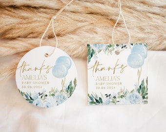 May include: Two round blue and white thank you tags with gold lettering. The tags say "Thanks Amelia's Baby Shower 30.06.2024". The tags have a watercolour design of blue and white flowers and leaves.