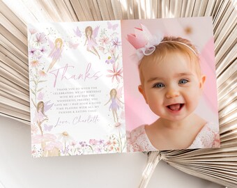 May include: A pink thank you card with a floral design and a photo of a baby girl wearing a pink crown. The text on the card reads "Thanks" and "Thank you so much for celebrating my 1st birthday with me and for the wonderful present you gave me! I had such a good time playing with all my friends & eating cake! Love, Charlotte."
