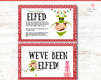 Op de afbeelding: Een feestelijke kerst-thema print met de tekst "You've Been Elfed!" en "We've Been Elfed!" in een speels lettertype. Het ontwerp bevat elf-illustraties, lichtslingers en cadeau dozen, alles tegen een rood-witte patroonrand.