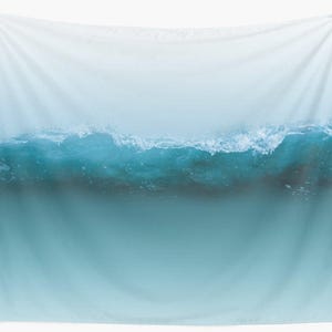 May include: A wall tapestry featuring a serene ocean wave design. The image showcases a gradient of colors, transitioning from a light blue at the top to a deeper teal at the bottom. The wave crests with white foam, creating a dynamic and calming visual.