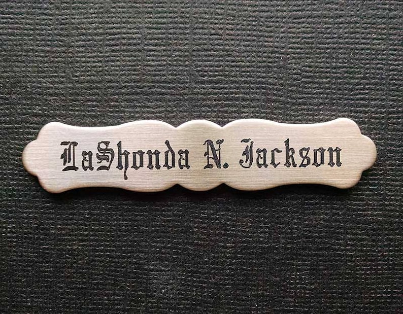 May include: A wooden nameplate with a decorative border and the name "LaShonda N. Jackson" engraved in black.